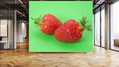 two Strawberries  on green background Wall mural