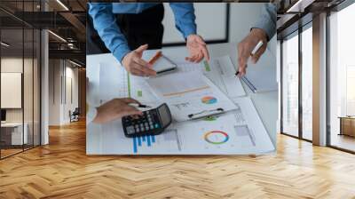 close-up hands image, Professional Asian male and female financial consultant or analyst working with them team, brainstorming and analyzing financial data on the report together in the office Wall mural