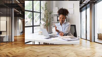 happy young businesswoman African American siting on the chiar cheerful demeanor raise holding coffee cup smiling looking laptop screen.Making opportunities female working successful in the office.	 Wall mural