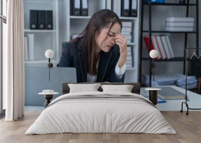 Stress at work, sitting with a stressed face, standing and stretching the body of an office woman. Wall mural