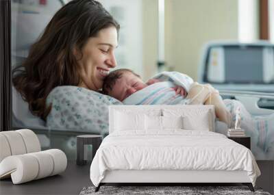 Cheerful new mother carrying and smiling to her newborn baby while resting on the hospital bed after giving birth Wall mural