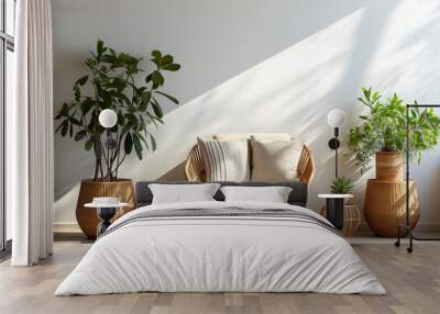 Cozy armchair with pillow, plants in vase on floor on gray wall background in living room. Boho style, modern design and blog about interior and furniture Wall mural