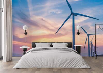 A group of wind turbines are lined up on a hillside Wall mural