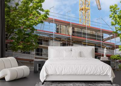 construction site with crane, facade with scaffolding Wall mural