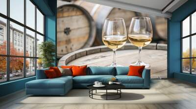 Two wine glasses rest on a rustic wooden barrel. Wall mural