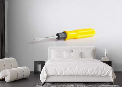 yellow metallic screwdriver on the white background Wall mural