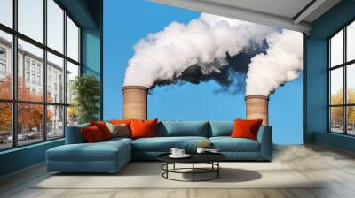 Close-up of two large smokestacks emitting thick white clouds against the blue sky, representing industrial air pollution. Wall mural