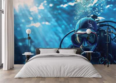 A man in a black wet suit is diving underwater Wall mural