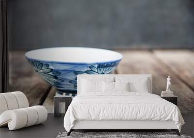 Blue bowl on wood table. Wall mural