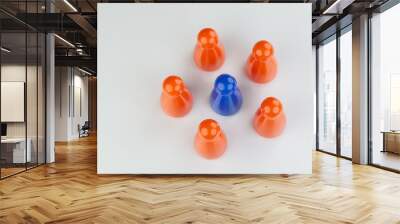 Conceptual orange game pawns and a blue play pawn Wall mural