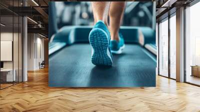 Feet on a treadmill move. Wall mural