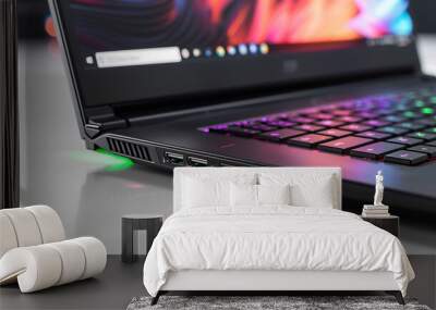 Laptop with a backlit keyboard and a green light on the side. Wall mural