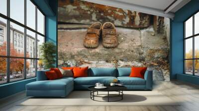 The image of a childs small shoes at the doorstep, a reminder of the innocence that deserves protection and care  Wall mural