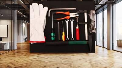 A set of new hand tools, mask, glasses and gloves on a black background. Wall mural