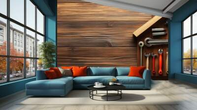 A house shape made of wood with various tools inside on a wooden background. Wall mural