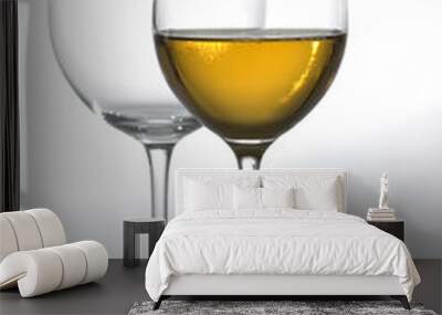 Two tall glasses, empty and filled with white wine Wall mural