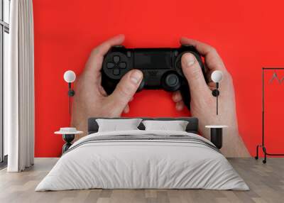 Man playing video game holding gaming controller in hands Wall mural