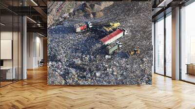 Aerial view taken from a helicopter of a landfill site in the UK. It contains trucks and machinery depositing rubbish as well as hundreds of gulls feeding on the garbage. Wall mural