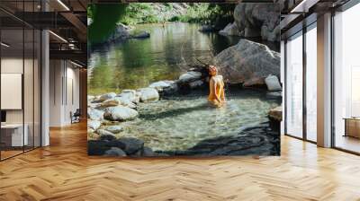 Female model flipping Hair in water at deep creek hot springs Wall mural