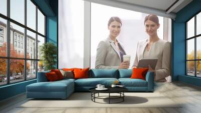 Businesswomen smiling in office Wall mural