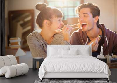 Couple eating sushi together in new home Wall mural