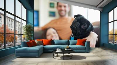 Couple relaxing with dog on sofa Wall mural