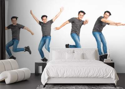  cheerful young man  jumping over white background Wall mural