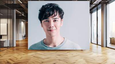  portrait of young smiling handsome man isolated on gray background Wall mural