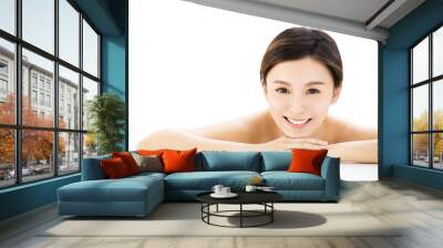 Beautiful woman  lying down on towel during skin care treatment Wall mural