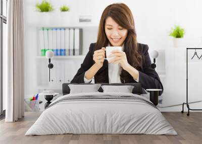 beautiful young business woman drinking coffee in office Wall mural