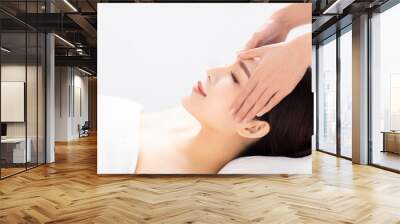 closed young woman face and head massage in spa Wall mural