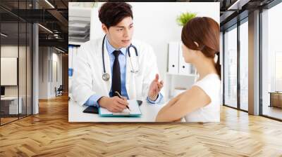 doctor talking with female patient in  office Wall mural