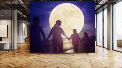 family walking on beach and watching the moon.Celebrate Mid autumn festival concept Wall mural