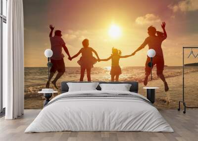 happy family jumping together on the beach Wall mural