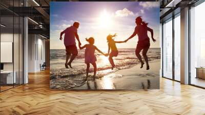 happy family jumping together on the beach Wall mural