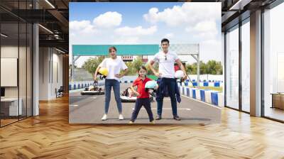 happy family standing on the go kart race track Wall mural