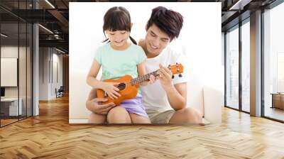 happy Father Teaching daughter To Play ukulele Wall mural