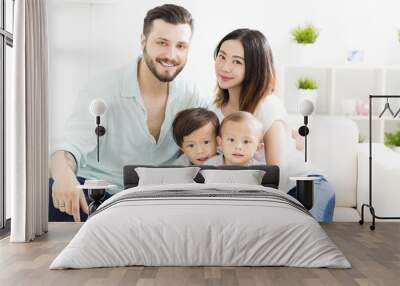 happy mixed race family in living room. Wall mural