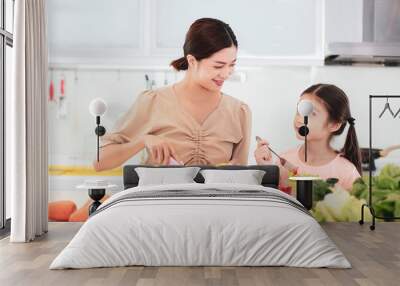 happy Mother and child daughter  eating the vegetables and fruit Wall mural