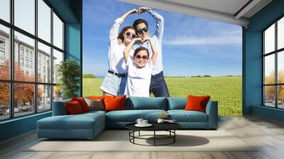 happy playful young family forming love shape Wall mural