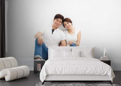 Happy Young Couple Sitting On Floor Wall mural