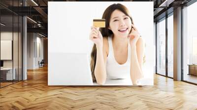 Happy Young Woman buying on line with credit card Wall mural