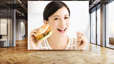 happy young  woman eating  big hamburger Wall mural