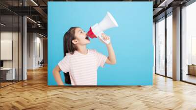 Little girl screaming and shouting with megaphone Wall mural