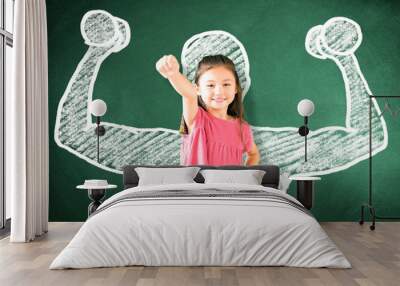 little girl standing against chalkboard and strong winner concept Wall mural