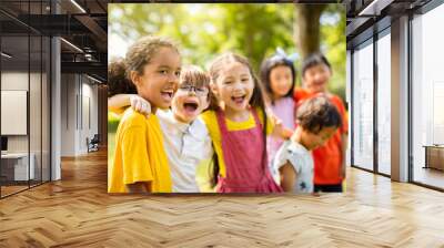 Multi-ethnic group of school children laughing and embracing Wall mural