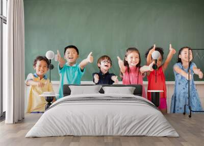 Multi-ethnic group of school children standing in classroom Wall mural