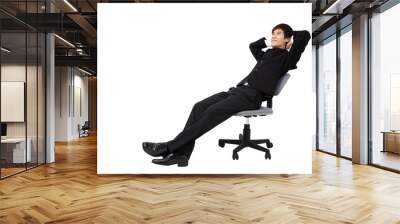 relaxed young businessman sitting on the chair Wall mural