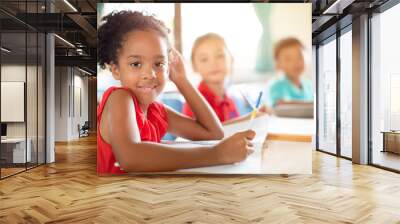 Smiling elementary school kids  in classroom Wall mural