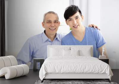 smiling senior father and adult son at home Wall mural